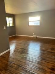 empty room featuring dark hardwood / wood-style flooring