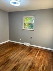 empty room with wood-type flooring