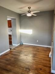 unfurnished room with dark hardwood / wood-style flooring and ceiling fan