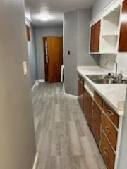 kitchen with sink and light wood-type flooring