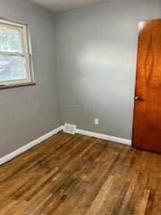 empty room featuring dark hardwood / wood-style floors