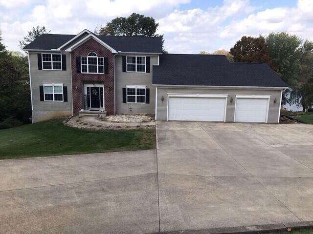 view of front of house with a garage and a front lawn