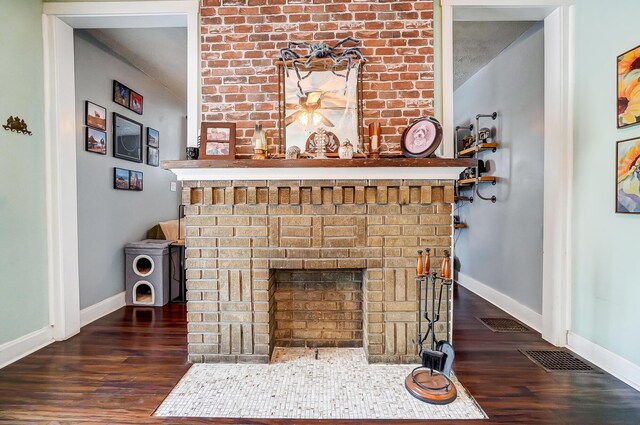 room details with hardwood / wood-style floors and a brick fireplace