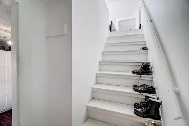 stairs featuring wood-type flooring