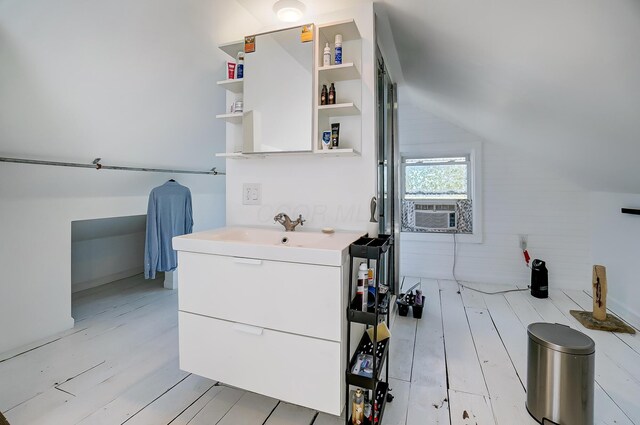 bathroom featuring cooling unit, vanity, vaulted ceiling, and hardwood / wood-style flooring