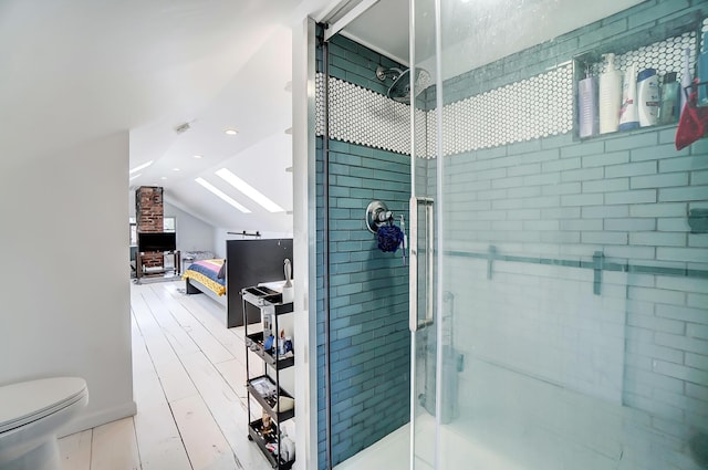 bathroom featuring toilet, lofted ceiling, and walk in shower