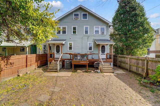 rear view of property featuring central air condition unit and a wooden deck