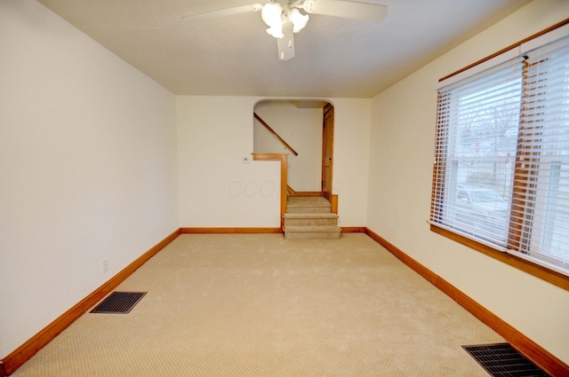 spare room with light carpet and ceiling fan