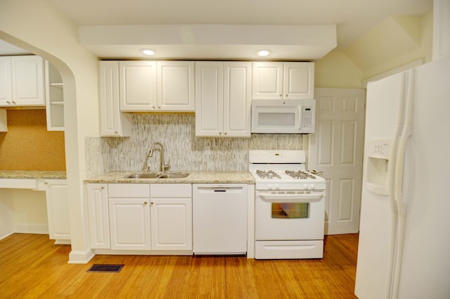 kitchen with white cabinets, light hardwood / wood-style floors, white appliances, and sink