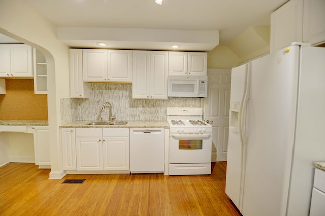 kitchen with backsplash, white appliances, sink, light hardwood / wood-style flooring, and white cabinets