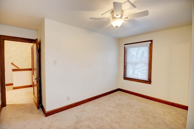 carpeted empty room with ceiling fan