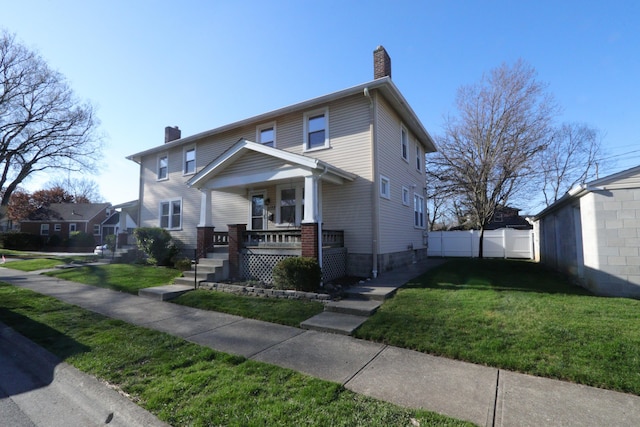 view of front of house with a porch and a front yard