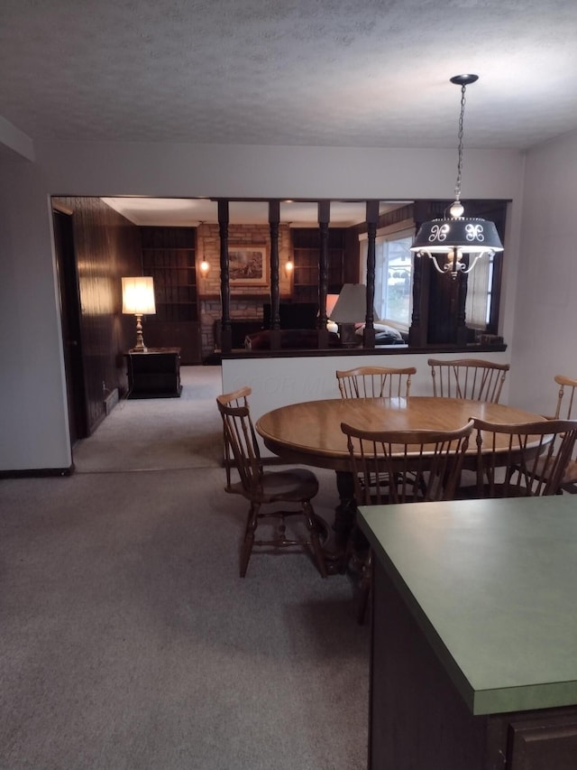 carpeted dining area featuring a textured ceiling and an inviting chandelier