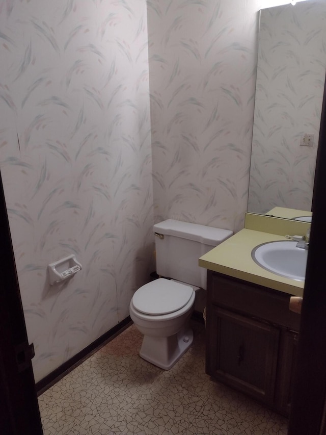 bathroom featuring tile patterned flooring, vanity, and toilet