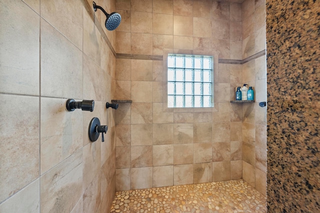 bathroom with tiled shower