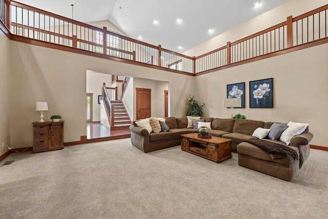 carpeted living room featuring a wealth of natural light and high vaulted ceiling