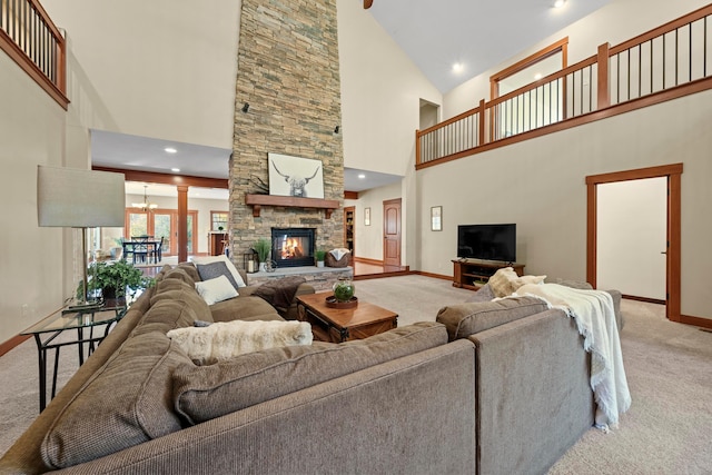 living room with a fireplace, light carpet, and high vaulted ceiling