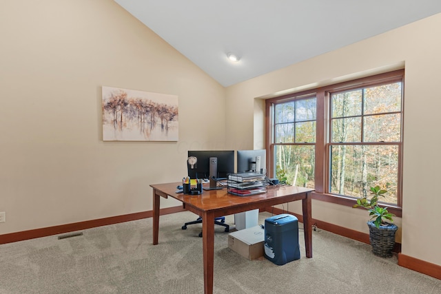 office with carpet floors and high vaulted ceiling