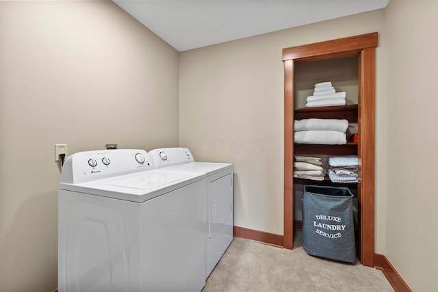 laundry room featuring washing machine and clothes dryer and light colored carpet