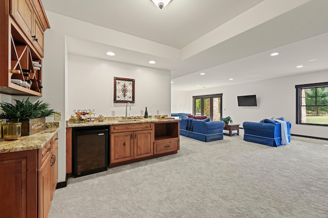 bar with light stone counters, light colored carpet, sink, and wine cooler