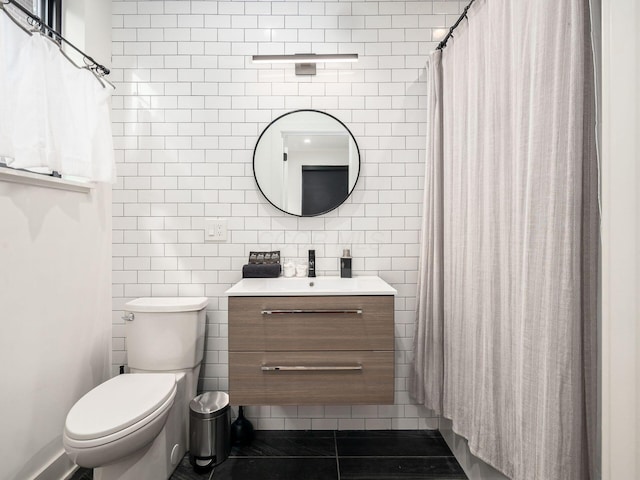 bathroom featuring tile patterned flooring, vanity, tile walls, and toilet