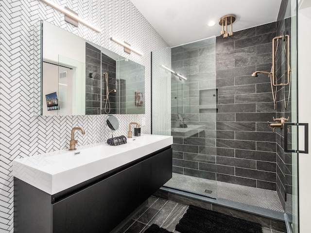 bathroom with backsplash, a tile shower, vanity, and tile walls