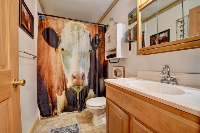 bathroom with vanity, curtained shower, toilet, and ornamental molding