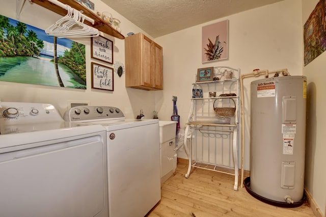 laundry area with cabinets, electric water heater, separate washer and dryer, a textured ceiling, and light hardwood / wood-style floors