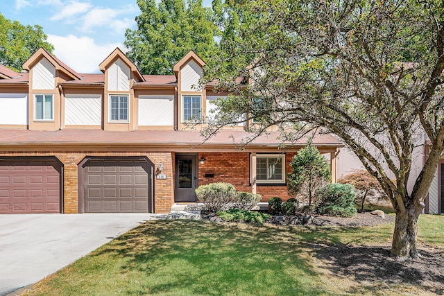 multi unit property featuring a front lawn, concrete driveway, and brick siding