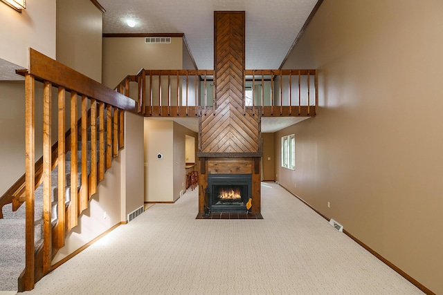 unfurnished living room with a fireplace with flush hearth, visible vents, and baseboards