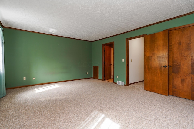 unfurnished bedroom featuring light carpet, baseboards, visible vents, and ornamental molding