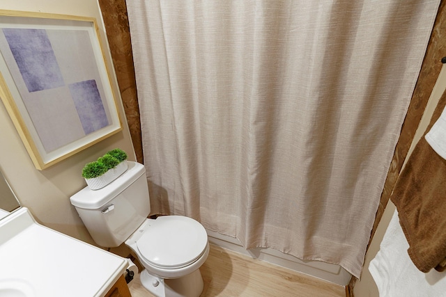 full bathroom with toilet, shower / bath combo with shower curtain, and vanity