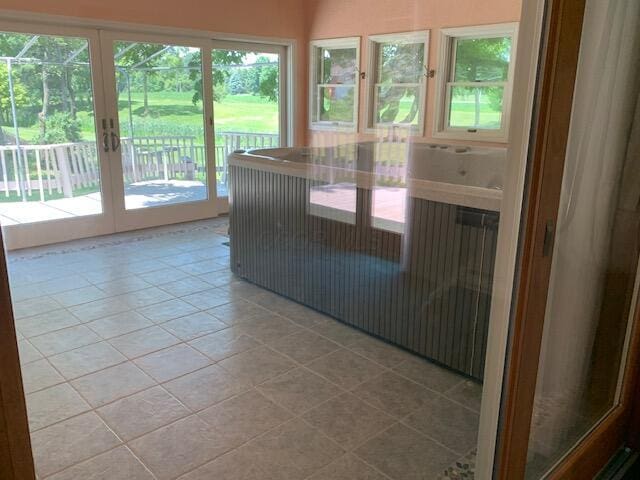 unfurnished sunroom with french doors