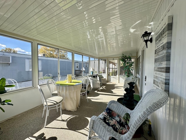 sunroom featuring vaulted ceiling