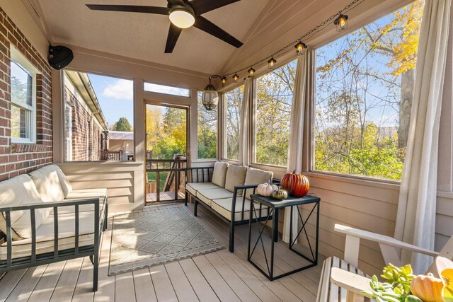 sunroom with ceiling fan and lofted ceiling