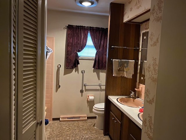 bathroom with tile patterned flooring, vanity, toilet, and a baseboard heating unit