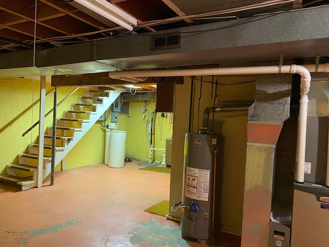 basement featuring heating unit and water heater