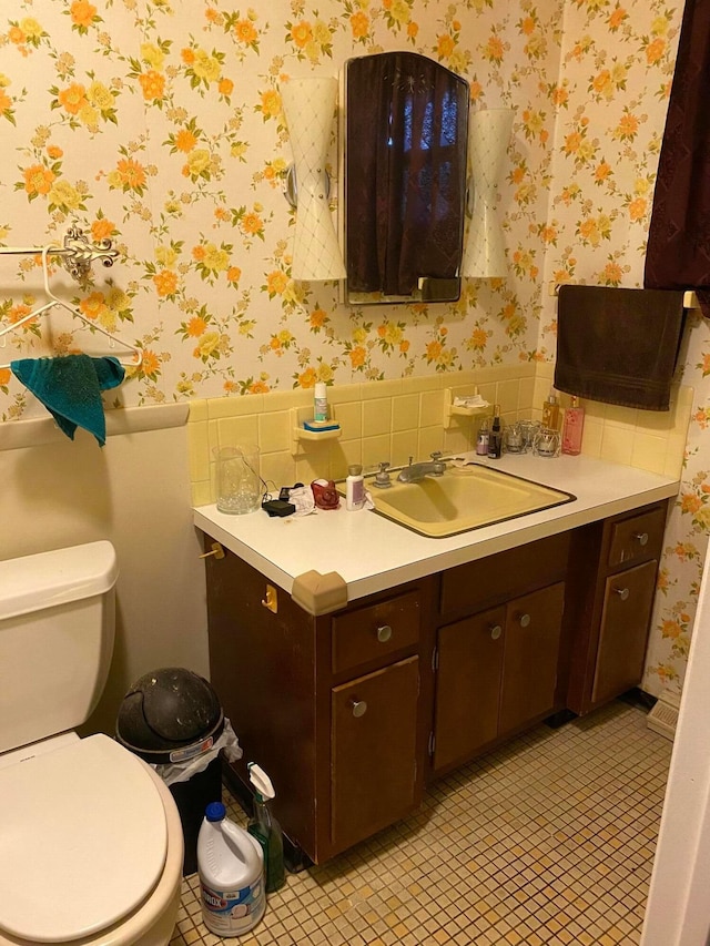 bathroom featuring tile patterned floors, vanity, and toilet