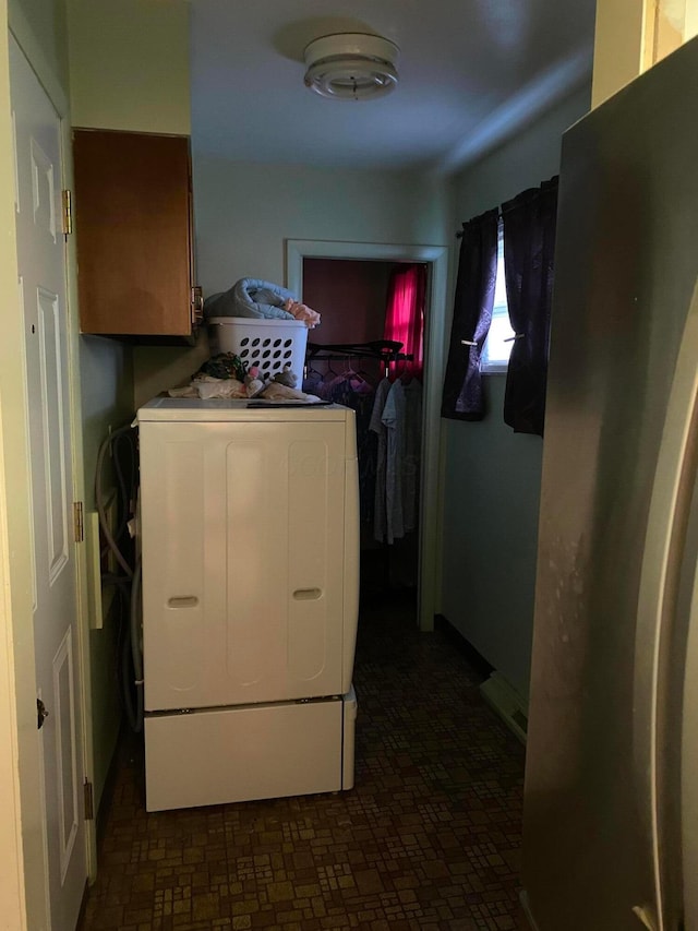 washroom with cabinets and washer / dryer