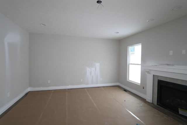 unfurnished living room with a tile fireplace