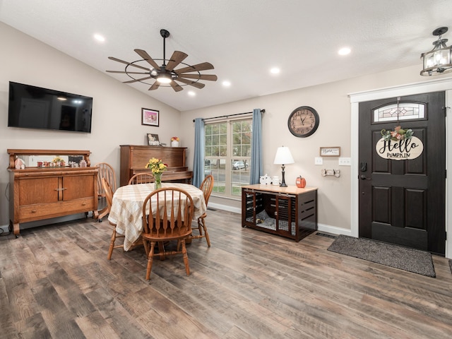 dining area featuring ceiling fan, wood-type flooring, lofted ceiling, and a textured ceiling