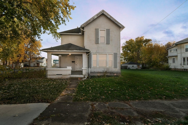 view of front of property featuring a lawn and covered porch