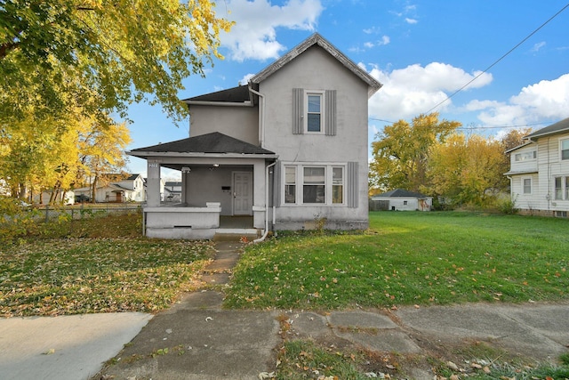 view of front of property with a porch and a front lawn