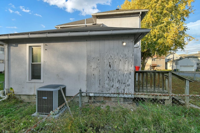 view of home's exterior with a deck and central air condition unit