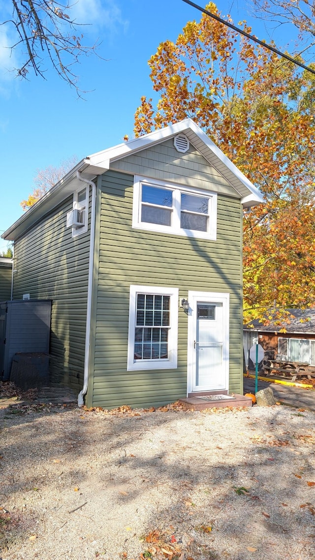 rear view of house with cooling unit