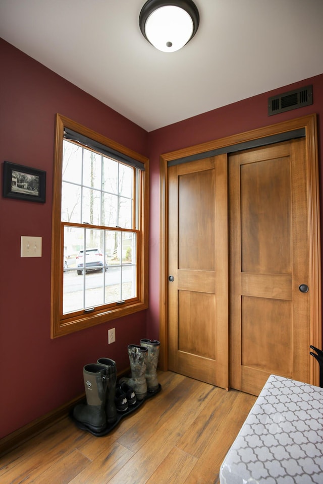 bedroom featuring light hardwood / wood-style flooring and a closet