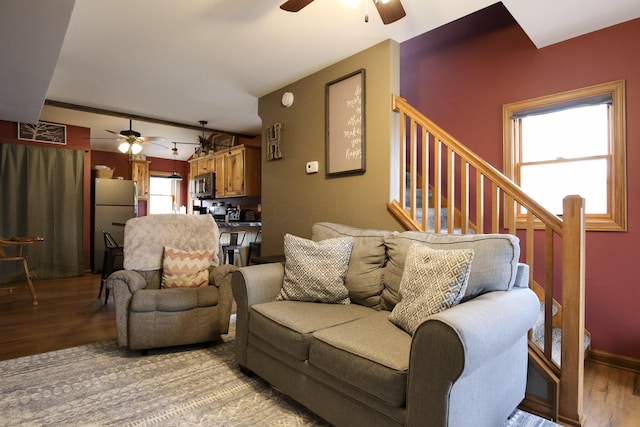 living room with light wood-type flooring and ceiling fan