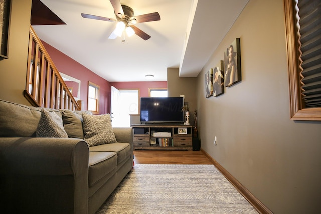 living room with ceiling fan and light hardwood / wood-style flooring