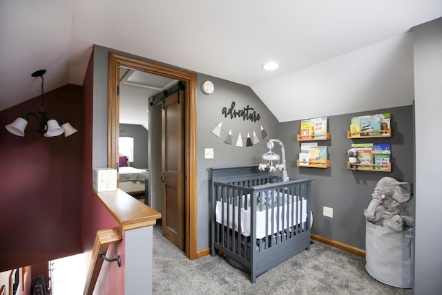 bedroom featuring lofted ceiling, a crib, and light carpet