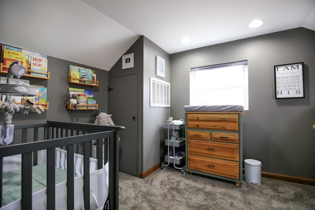 bedroom featuring carpet flooring, vaulted ceiling, and a crib